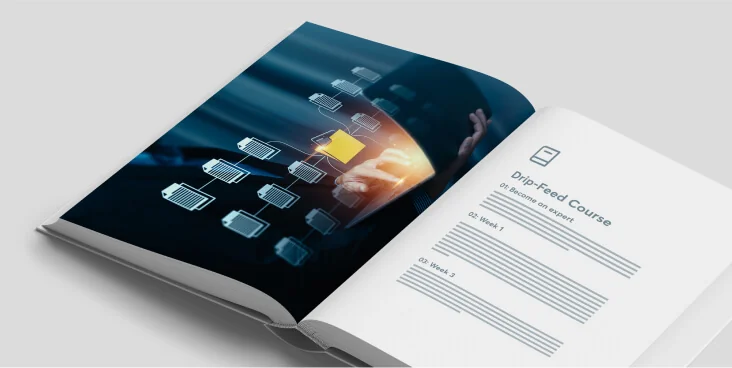 Open booklet displays a hand tapping a glowing network node on a dark left-page graphic; right white page shows a course outline while the book rests...