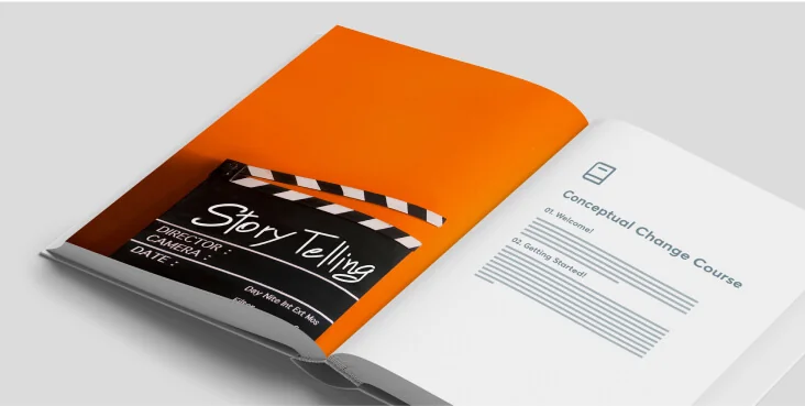 Open book displays a film clapperboard labeled "Story Telling" and a course page titled "Conceptual Change Course," resting on a light gray surface.