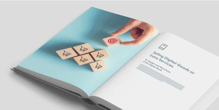 Hand places a wooden block with a red target icon atop a pyramid of wooden blocks bearing shopping-cart icons on a teal left page of an open book;...
