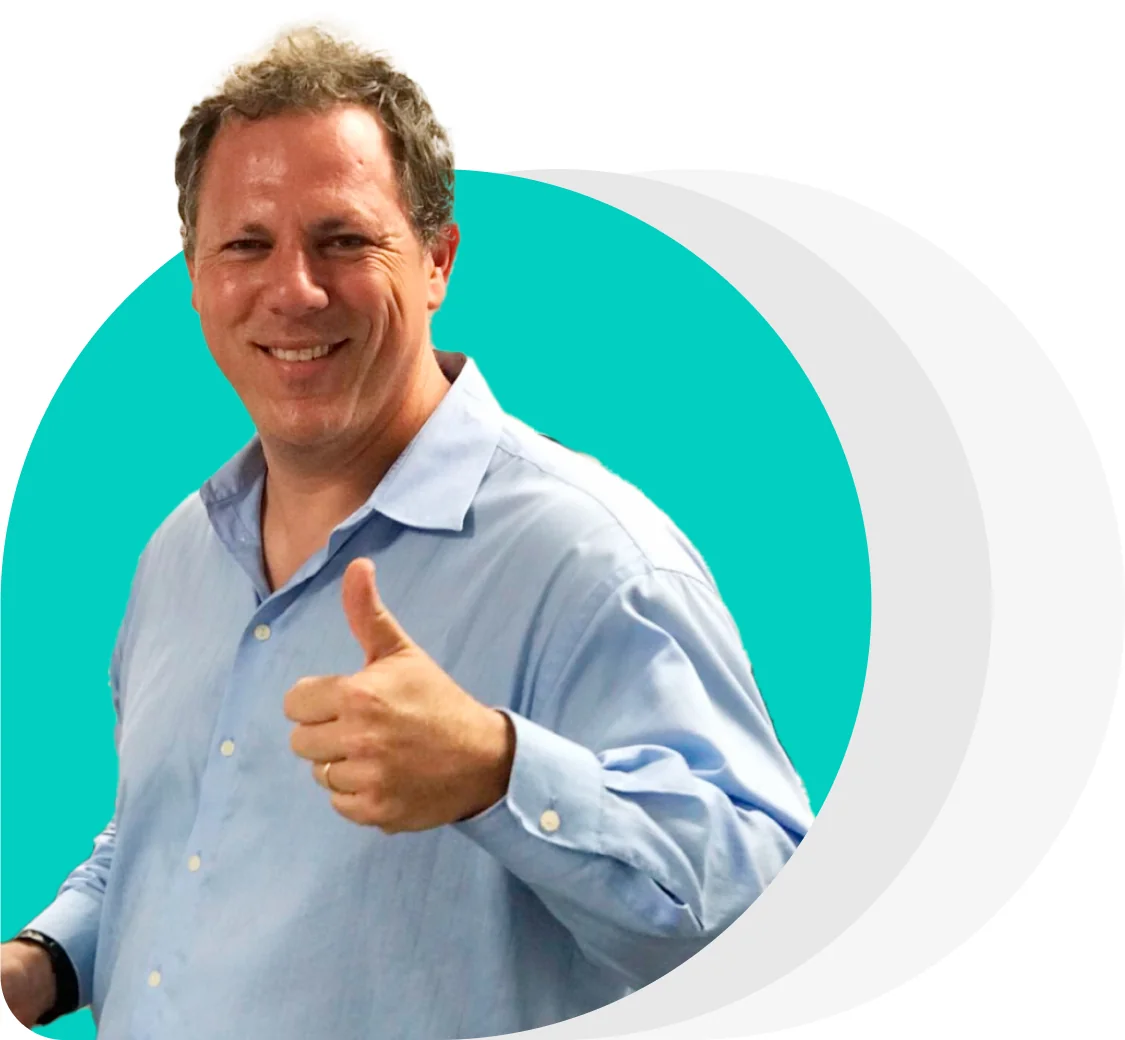Smiling man gives a thumbs-up; wearing a light-blue button-down shirt; standing in front of a teal circular backdrop with overlapping pale-gray arcs...