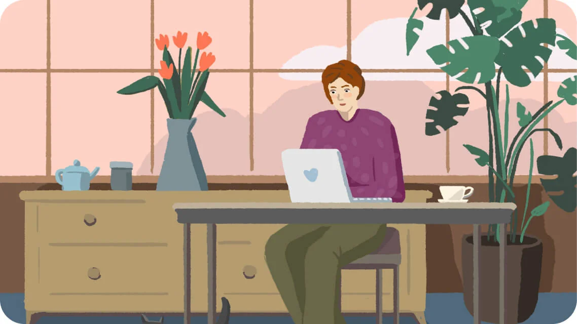 Person seated at a table, working on a laptop; sunlit room with large paned window, sideboard holding a vase of tulips and a teapot, and a potted...