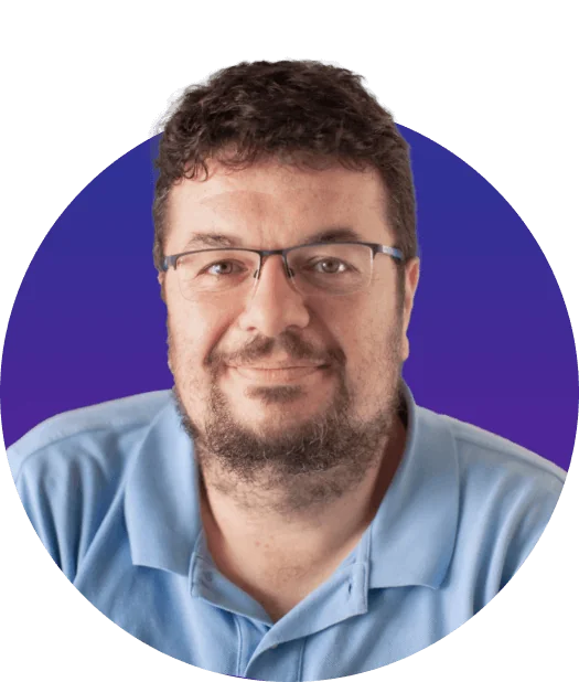 A bearded man wearing glasses and a light-blue polo looks directly at the camera with a gentle smile, framed by a circular purple-to-blue gradient...