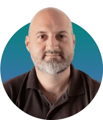 A bald, graying-bearded man gazes directly at the camera with a neutral expression, wearing a dark polo and centered against a circular teal-to-blue...