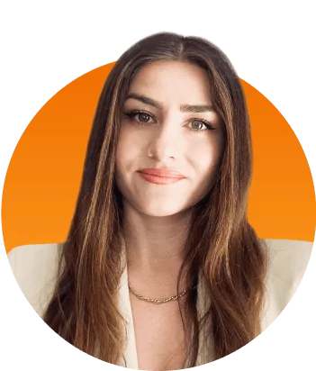 Woman faces camera with a subtle smile, long brown hair, wearing a light blazer and thin gold chain necklace, set against a circular orange gradient...