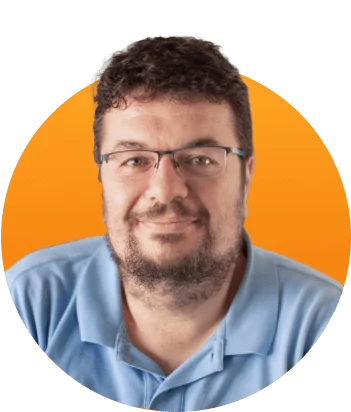 Bearded middle-aged man wearing glasses and a light blue polo smiles gently in a head-and-shoulders portrait set against a circular orange gradient...
