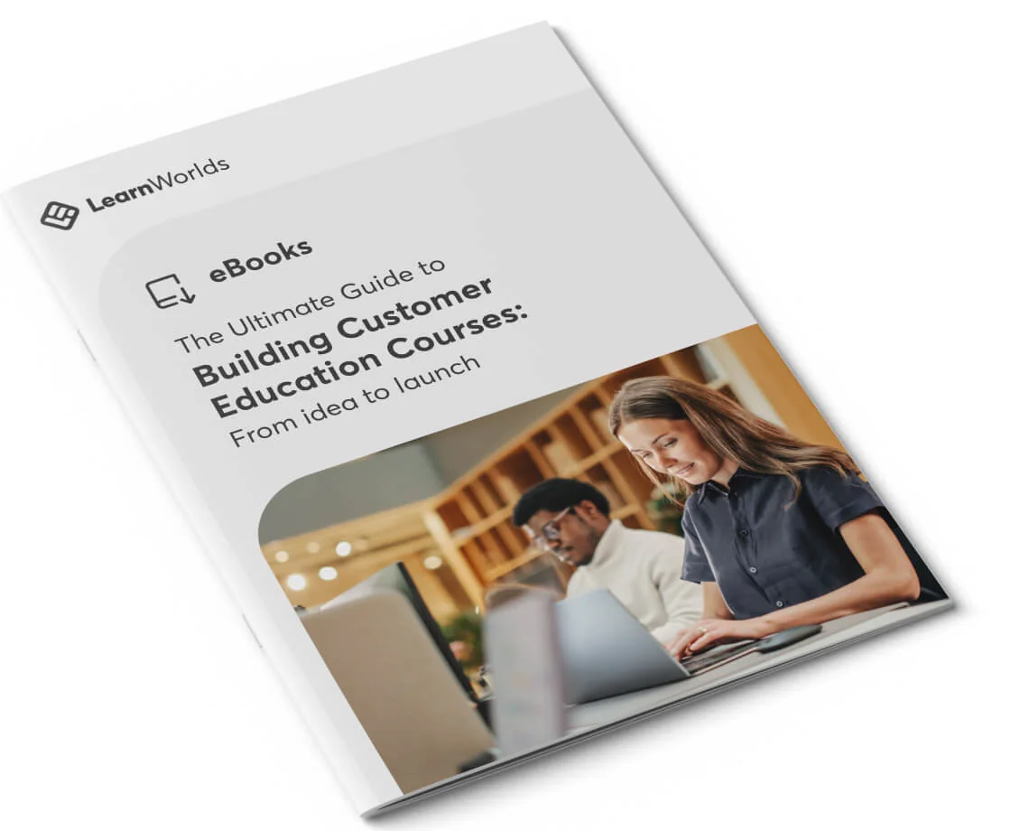 A printed booklet cover shows a smiling woman typing on a laptop while a man works behind her, placed on a white background at a slight angle;...